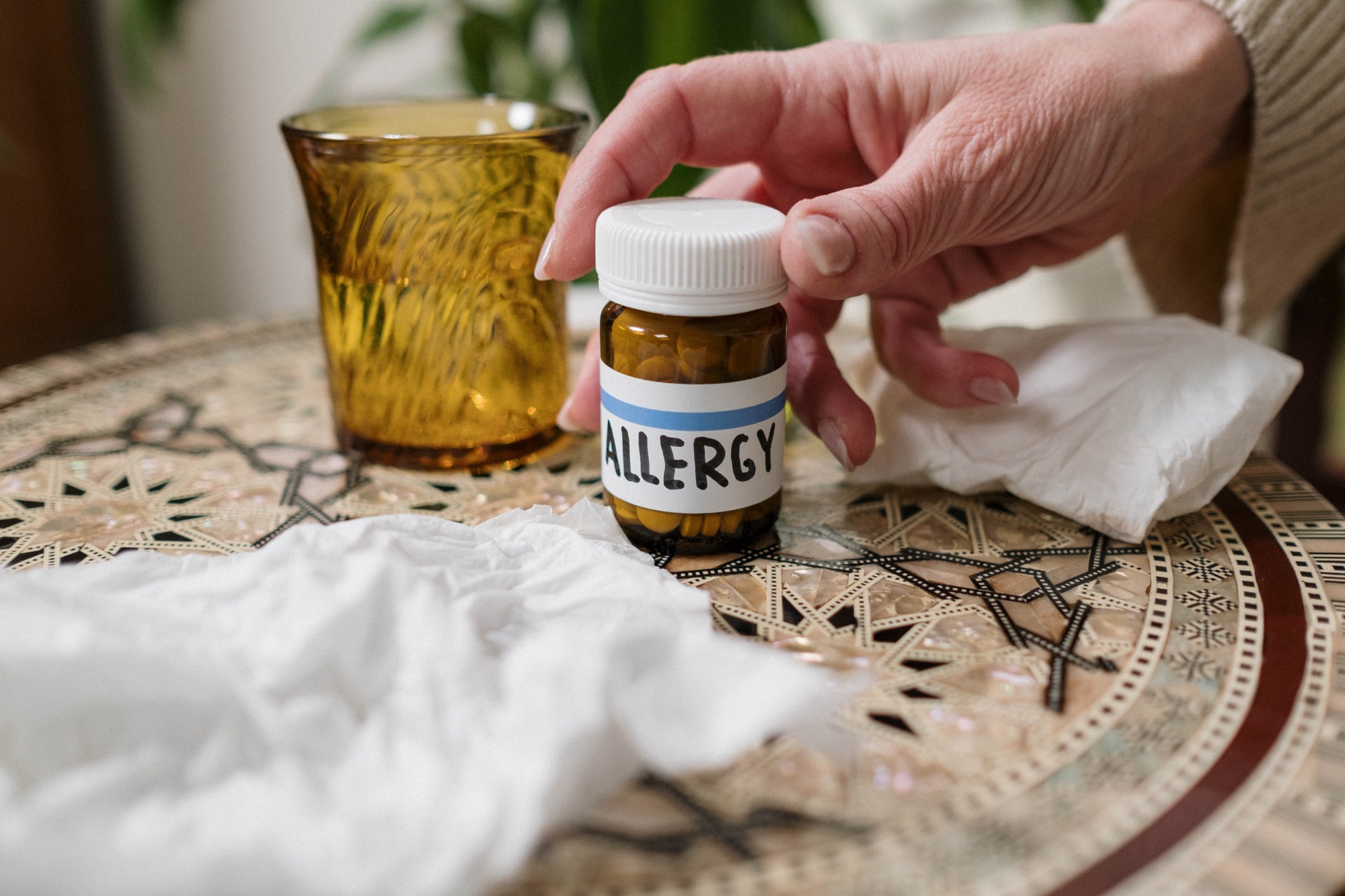 A close-up image of a pill bottle with the word "Allergy" prominently written on the label.